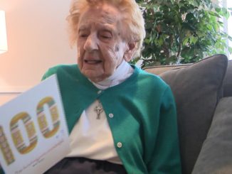 Sister Francis holding her 100th birthday cake card